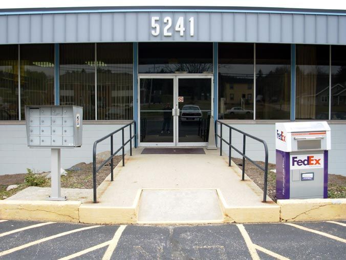 A fedex box sits in front of a building