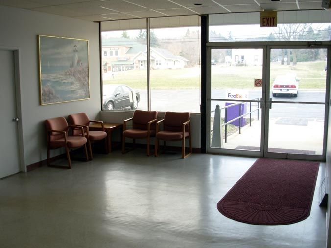 A waiting room with chairs and an exit sign