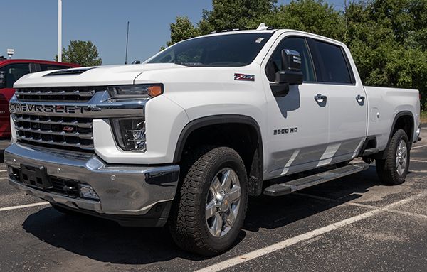 A white pickup truck is parked in a parking lot.