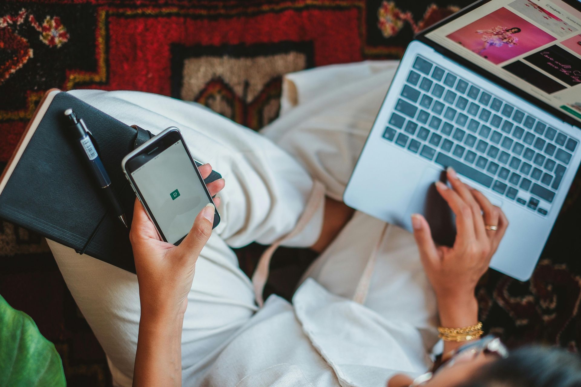 Person renting a storage unit online using phone and laptop