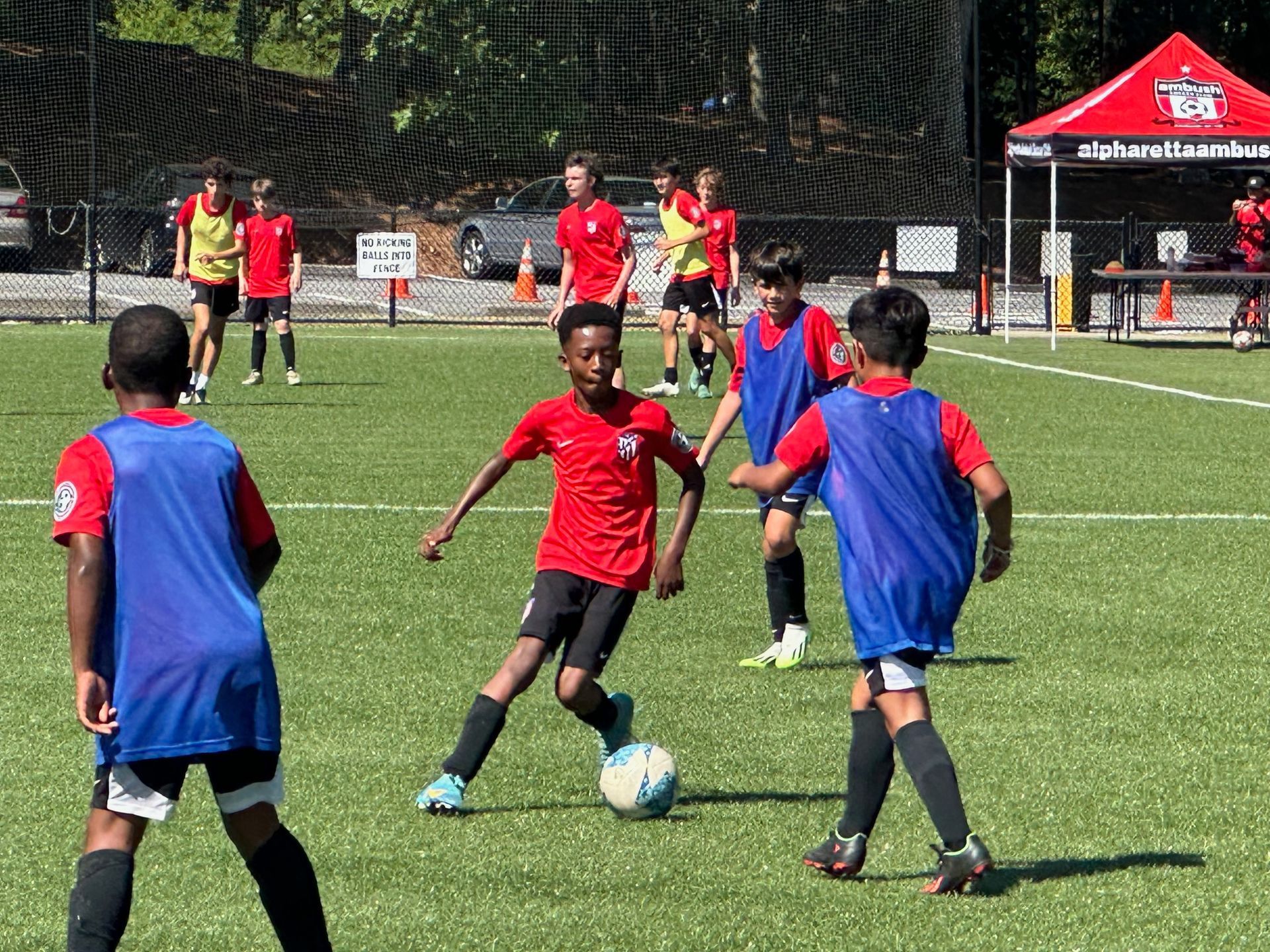 A group of young boys are playing soccer for Ambush Academy