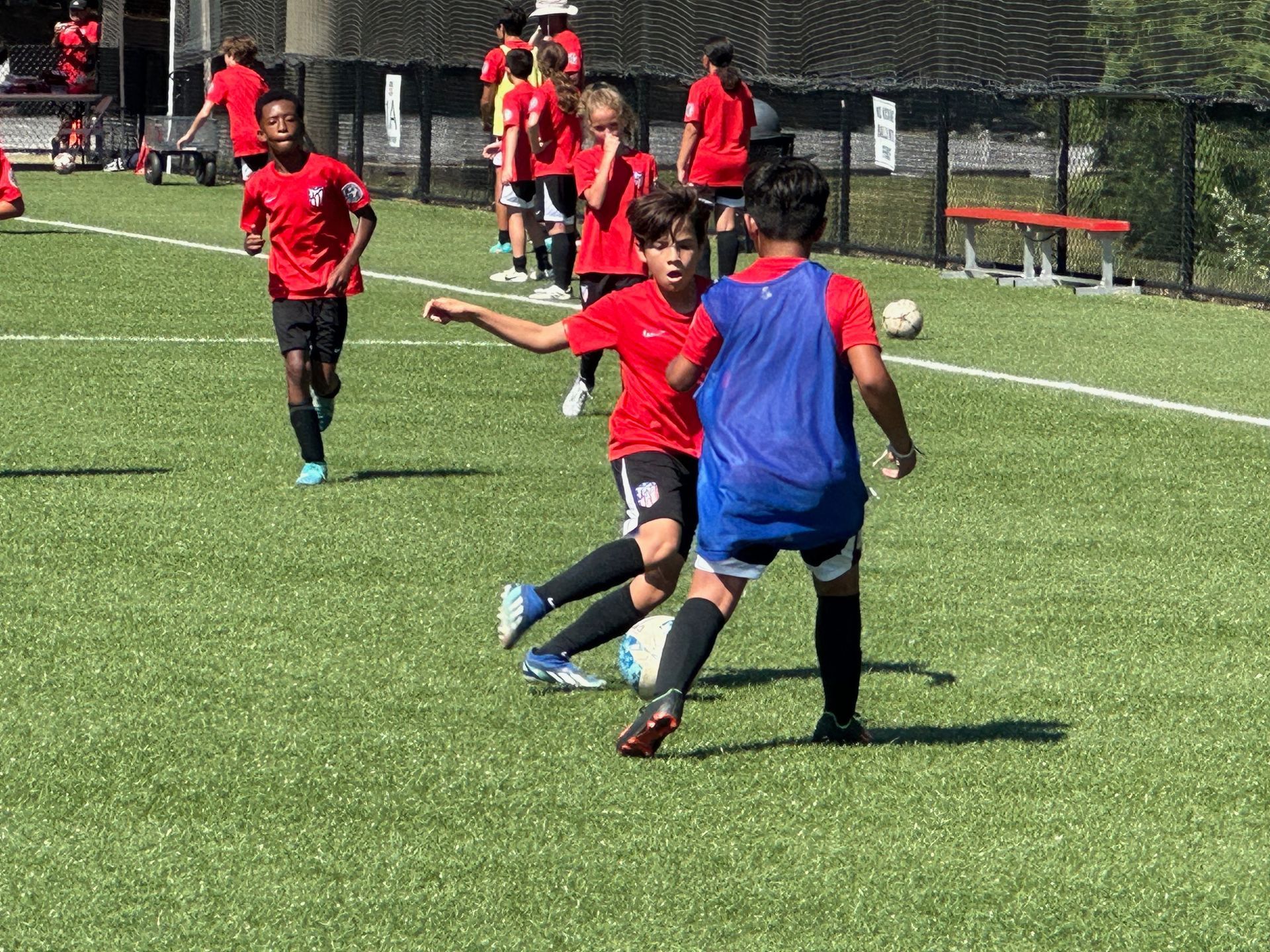 A group of young boys are playing soccer for Ambush Academy