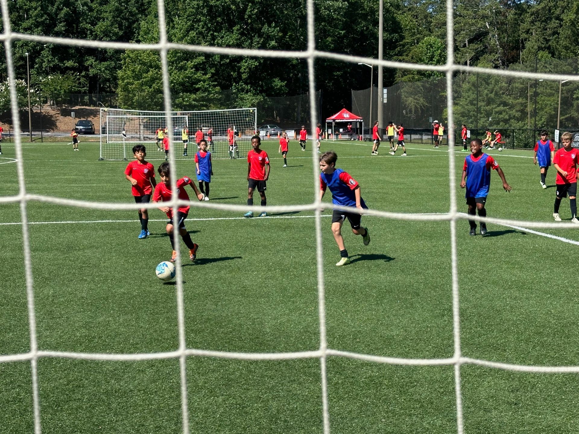 A group of young boys are playing soccer for Ambush Academy