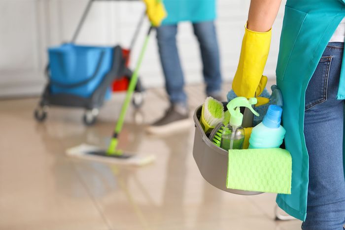 Woman Holding Cleaning Materials