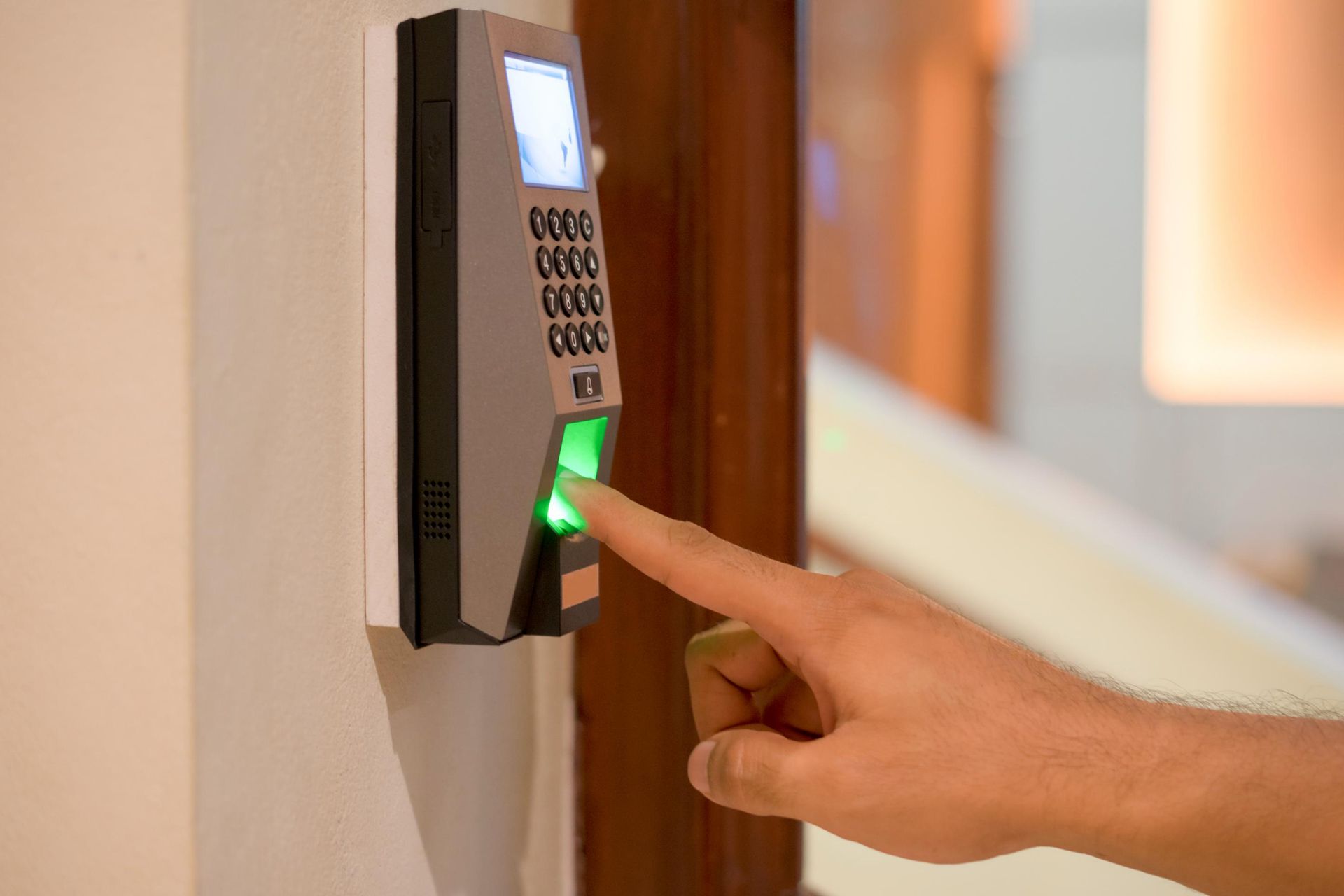 A person is pressing a button on a door with their finger.