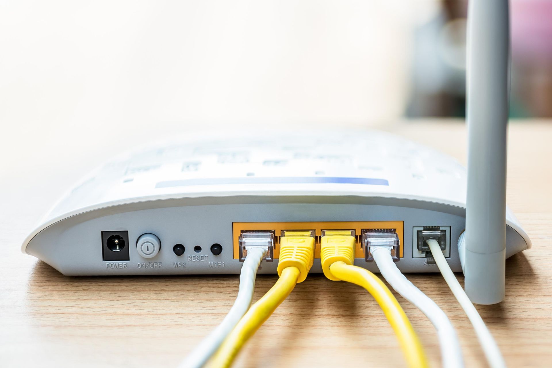 A close up of a router with cables plugged into it.