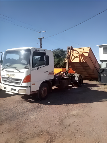 Blue Dumpster Being Loaded Onto a Truck by a Hydraulic Arm — Mount Isa Skips In Cloncurry, QLD