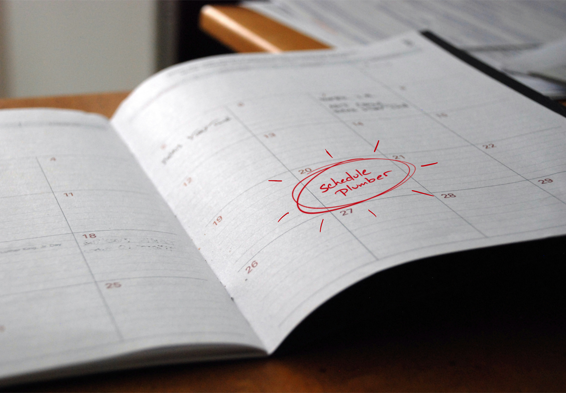 Open planner with a red circled date on a desk