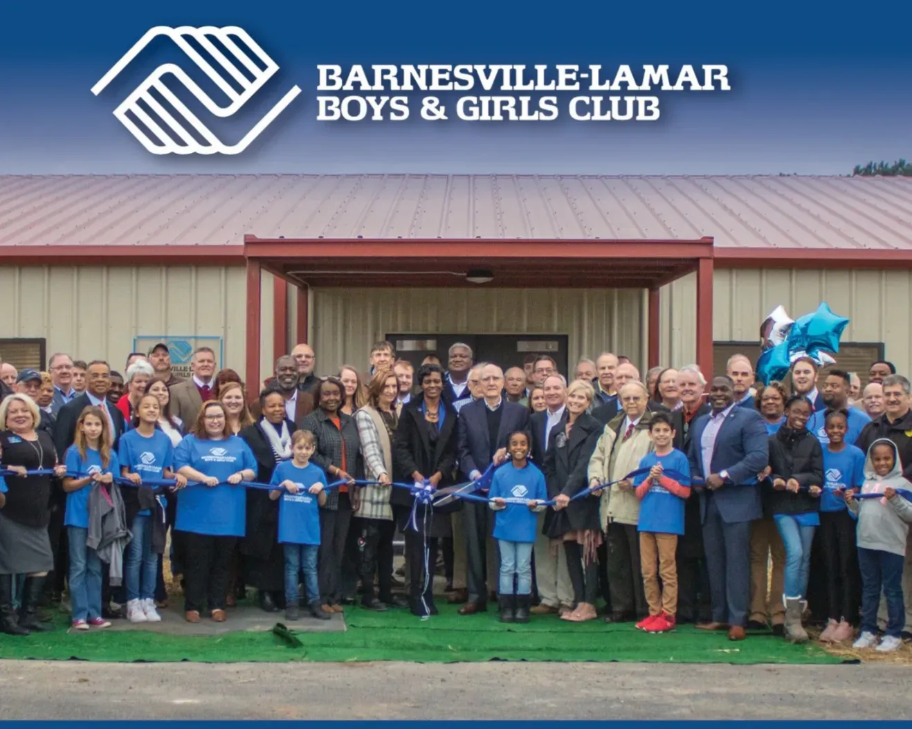 Barnesville-Lamar Boys & Girls Club ribbon-cutting with a crowd gathered outside the building