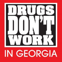 Red sign with bold white text: “DRUGS DON’T WORK IN GEORGIA.”