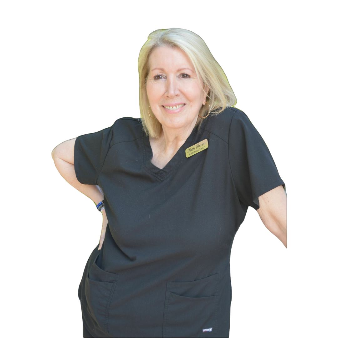 A woman wearing a black scrub top with a name tag on it
