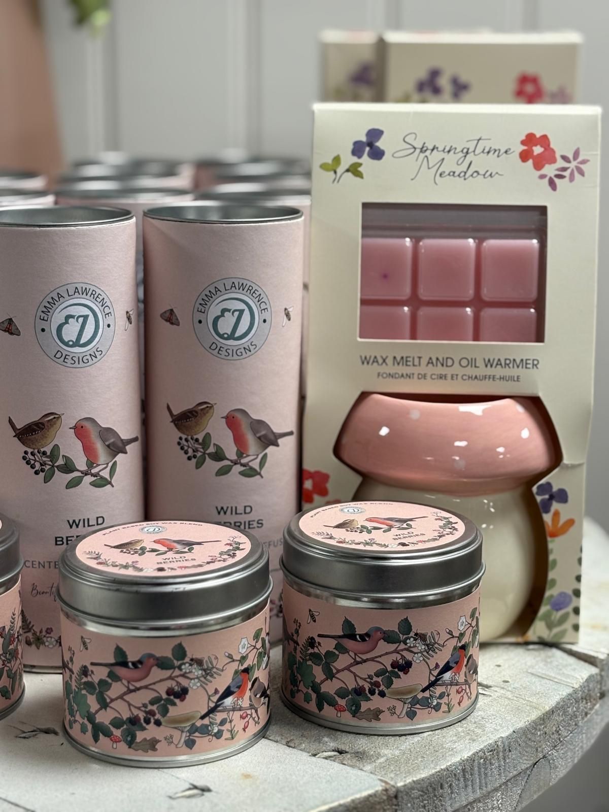 Pink scented candles, wax melts, and warmer set with floral and bird designs.