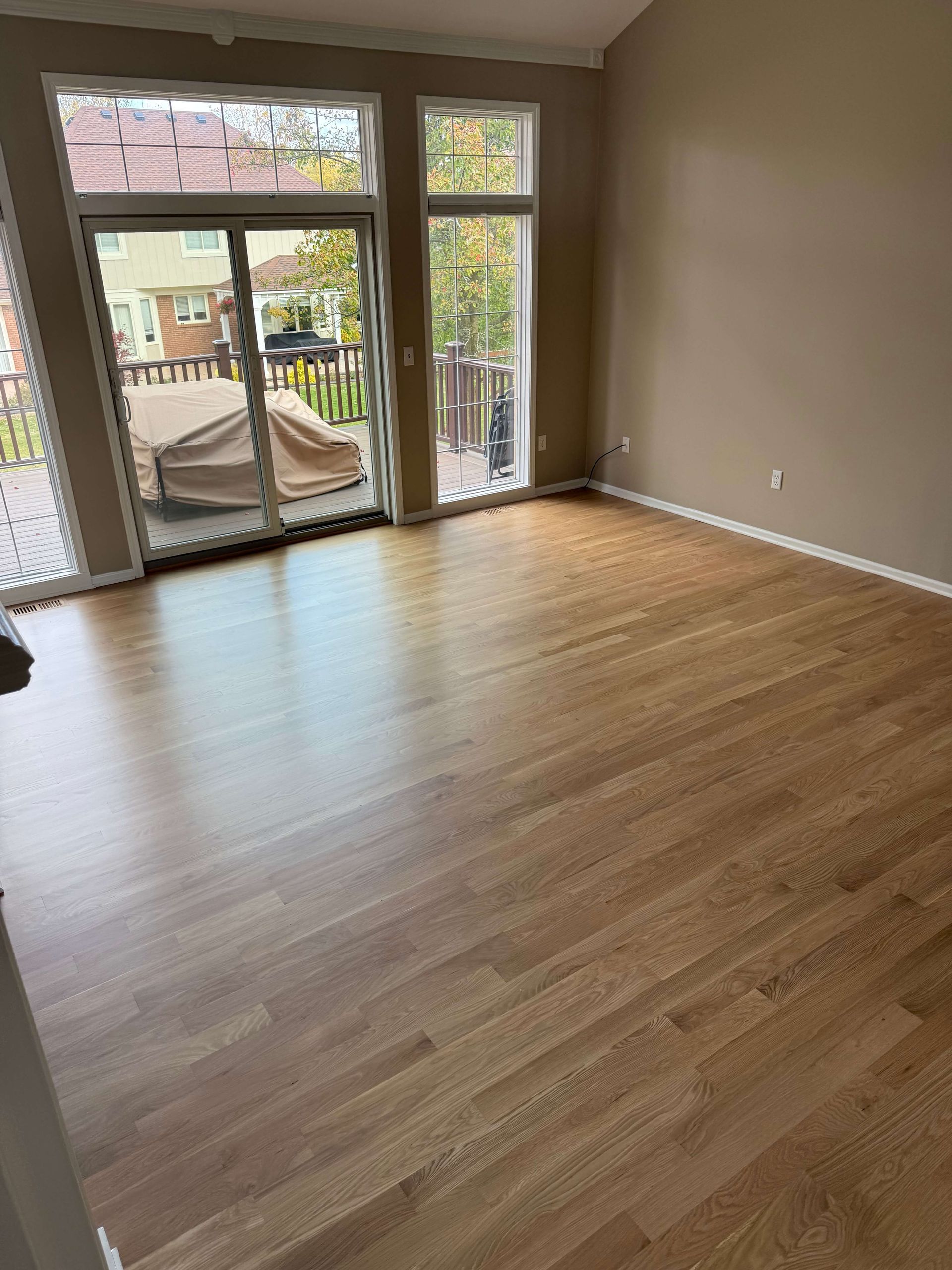 Living room with hardwood floors and large sliding glass doors to a balcony.
