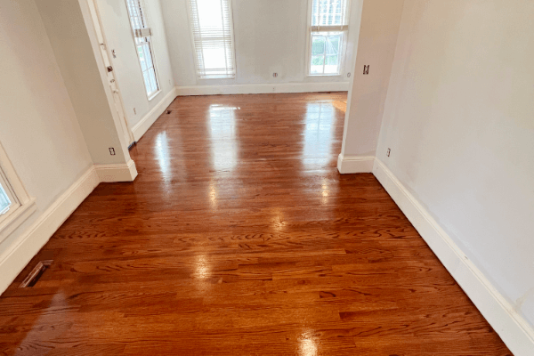 A bunch of different colored wooden boards are lined up on a wooden floor.