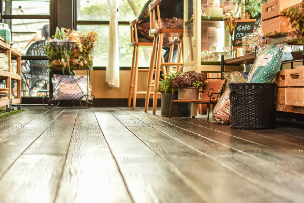 A wooden floor with a sign that says cafe on it