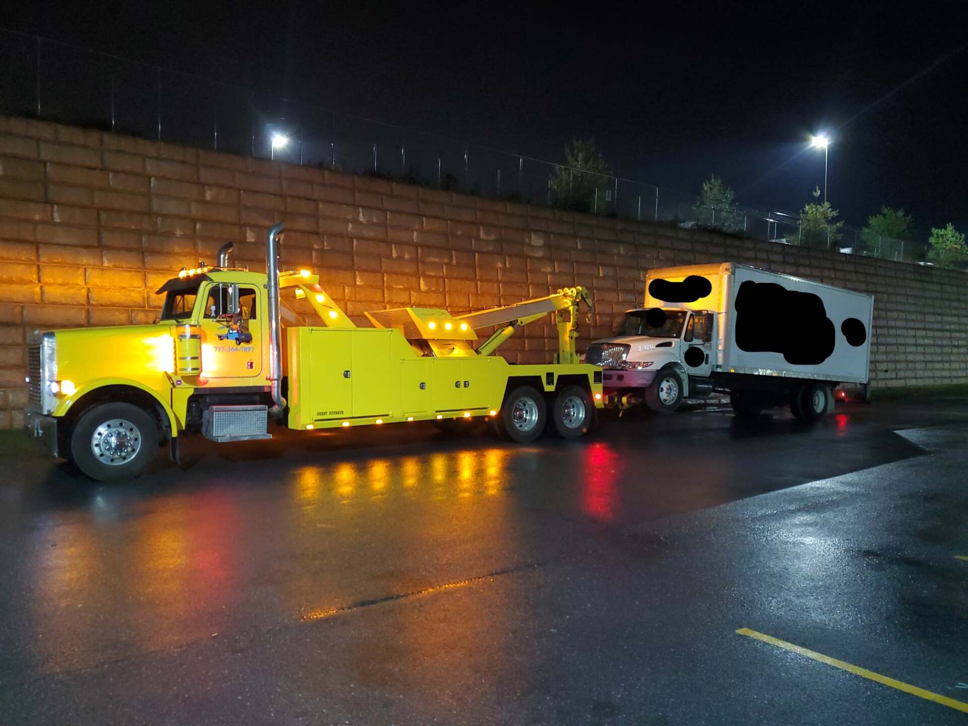 Yellow tow truck pulling truck - Harrisburg, PA - Dingman’s Towing and Recovery LLC