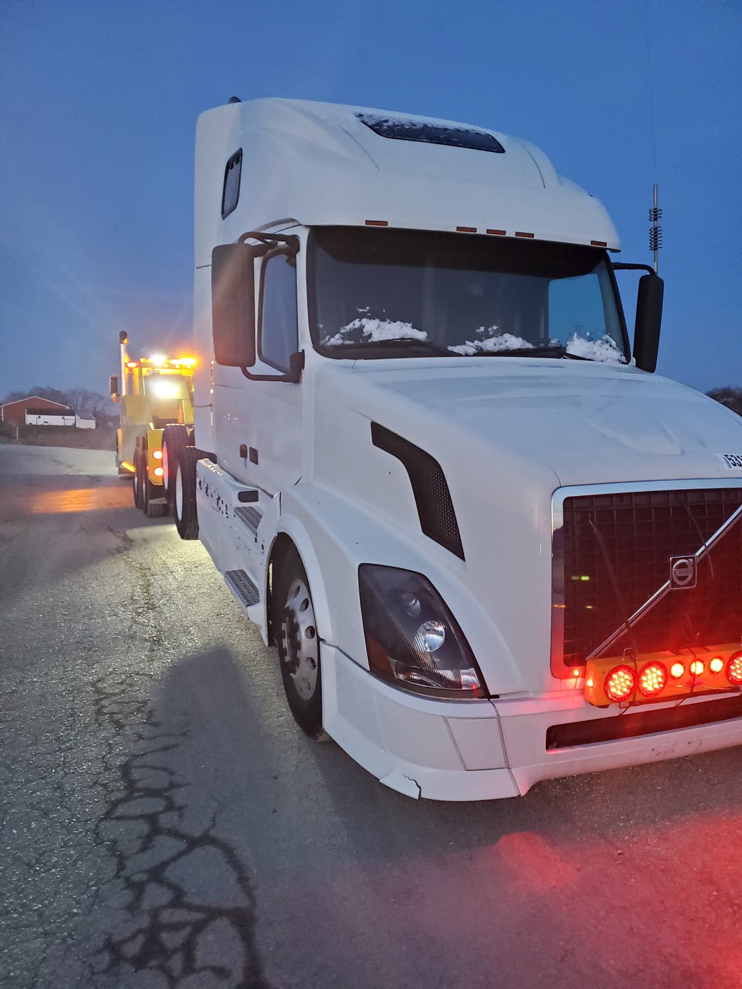 White tow truck with lights on - Harrisburg, PA - Dingman’s Towing and Recovery LLC