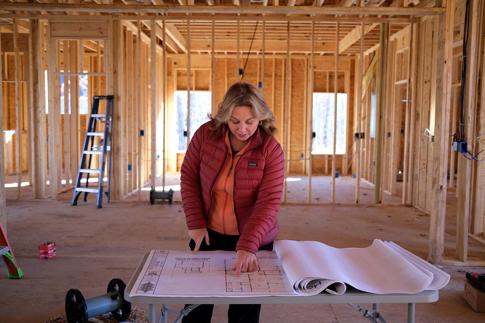 Collette Branham reviewing building plans at a TriStar Custom Homes job site in Chattanooga
