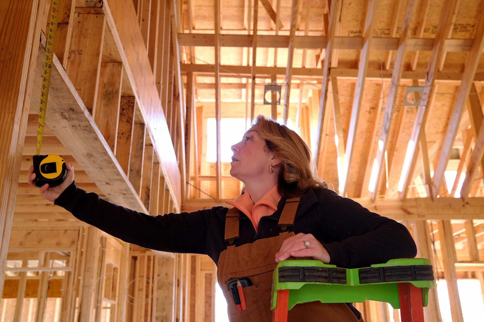 Collette Branham inspecting wood framing during a TriStar custom home build in Chattanooga
