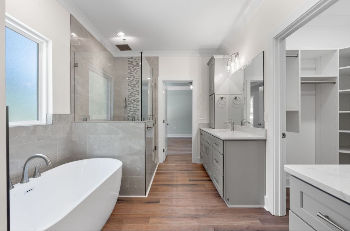 Custom home builder in Chattanooga presents a luxury bathroom with soaking tub, walk-in shower, and dual vanity cabinetry.
