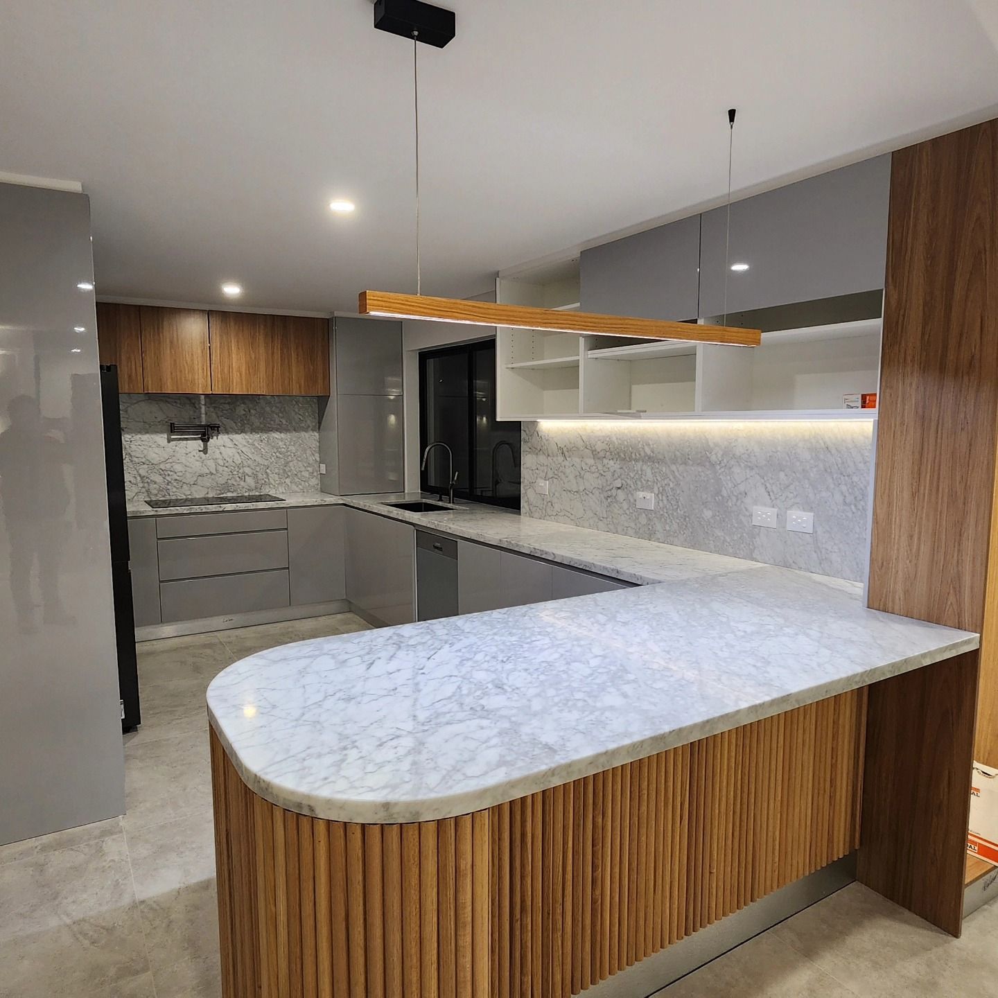 A Brown Kitchen With White Countertops — Professional Electrical & Data Pty Ltd in Bonner, ACT