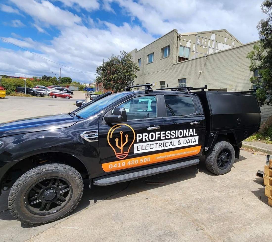 A Black Truck With the Words Professional Electrical & Data — Professional Electrical & Data Pty Ltd in Bonner, ACT
