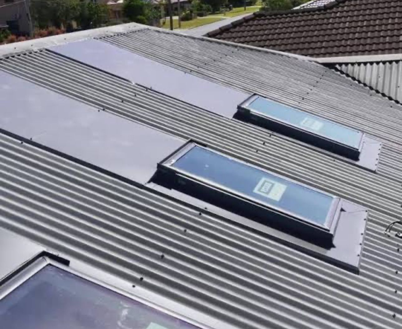 A Grey Roof With Three Skylights  — CBR Maintenance In Queanbeyan, NSW