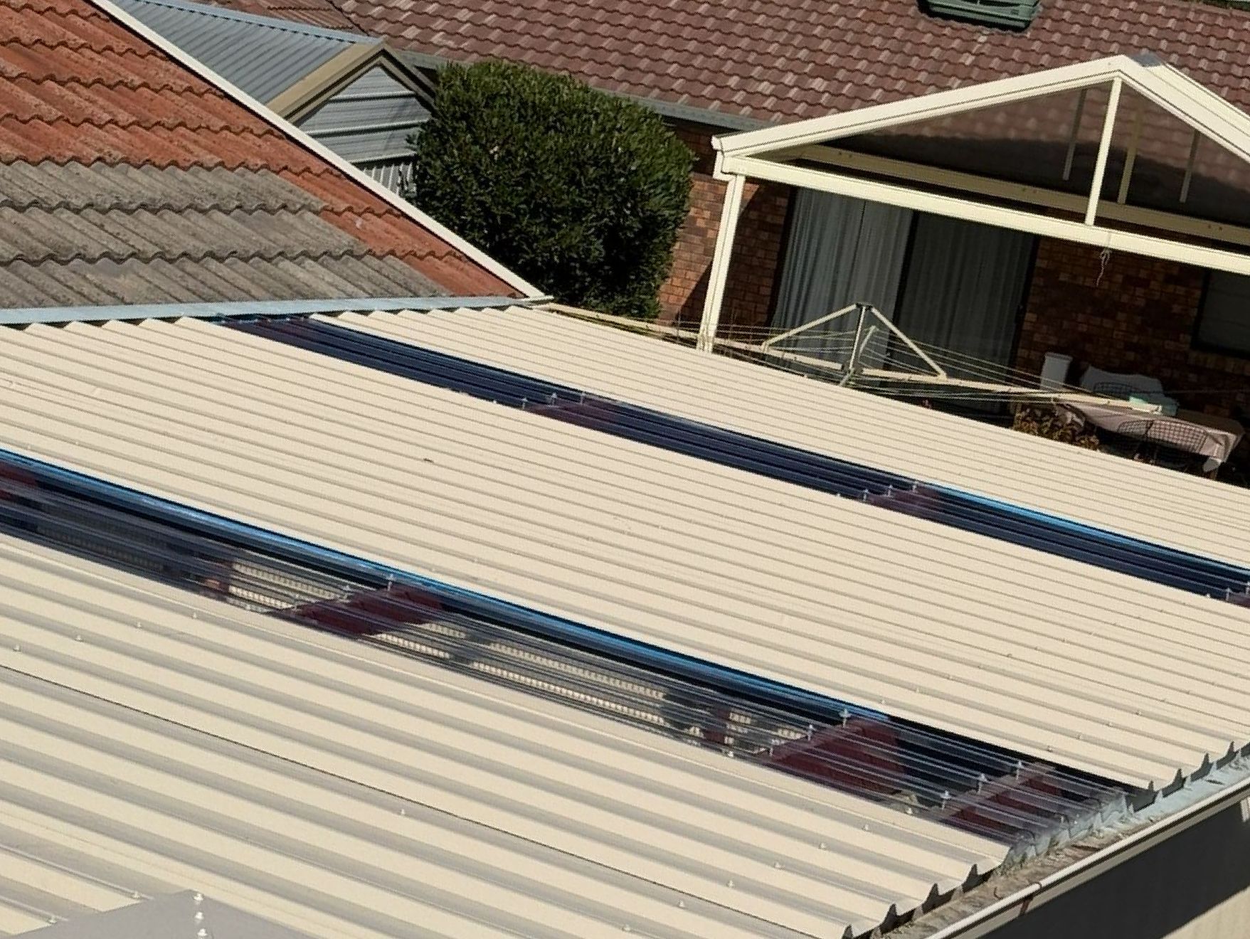 An Aerial View of a House With a Cream Roof  — CBR Maintenance In Queanbeyan, NSW