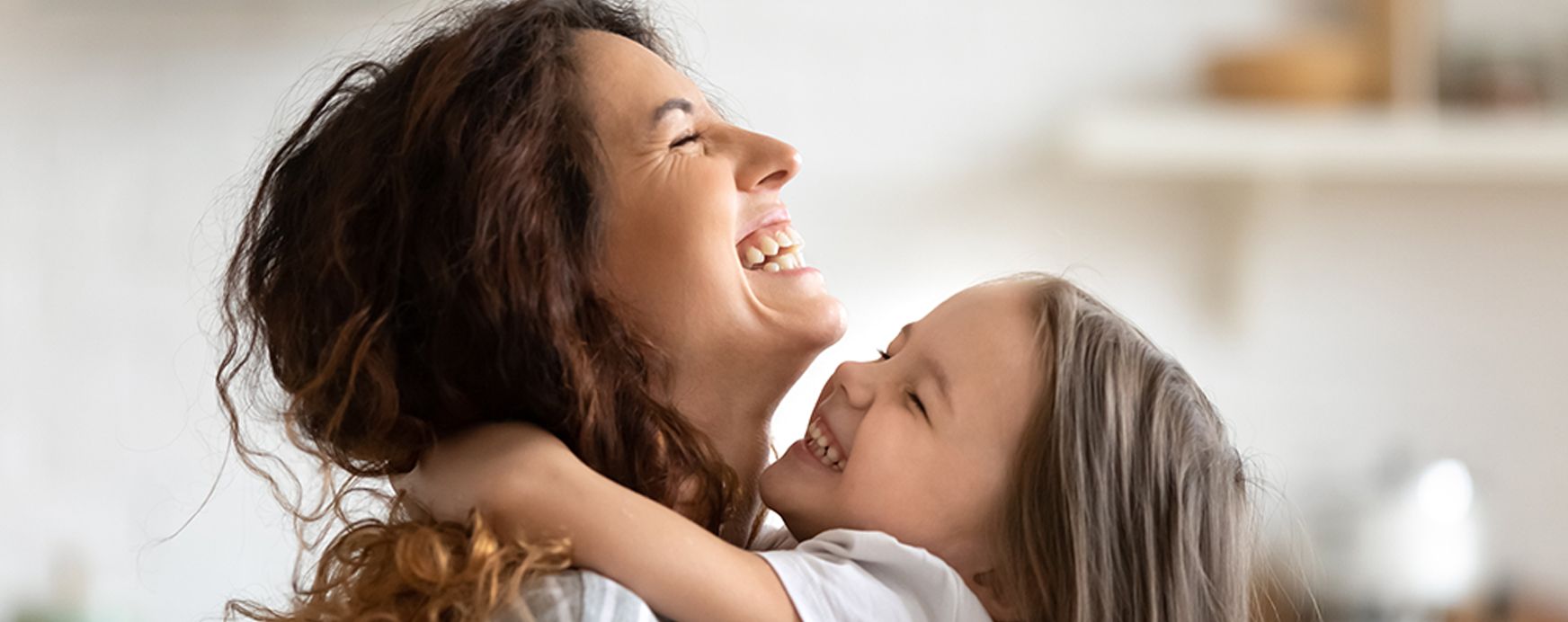 A woman is holding a little girl in her arms.