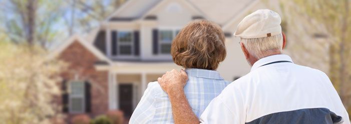 Senior couple looking at the exterior of the home