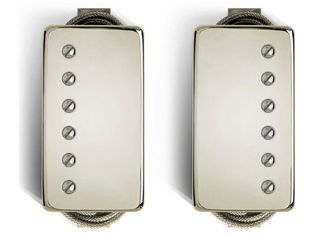 Two silver humbucker pickups for an electric guitar.