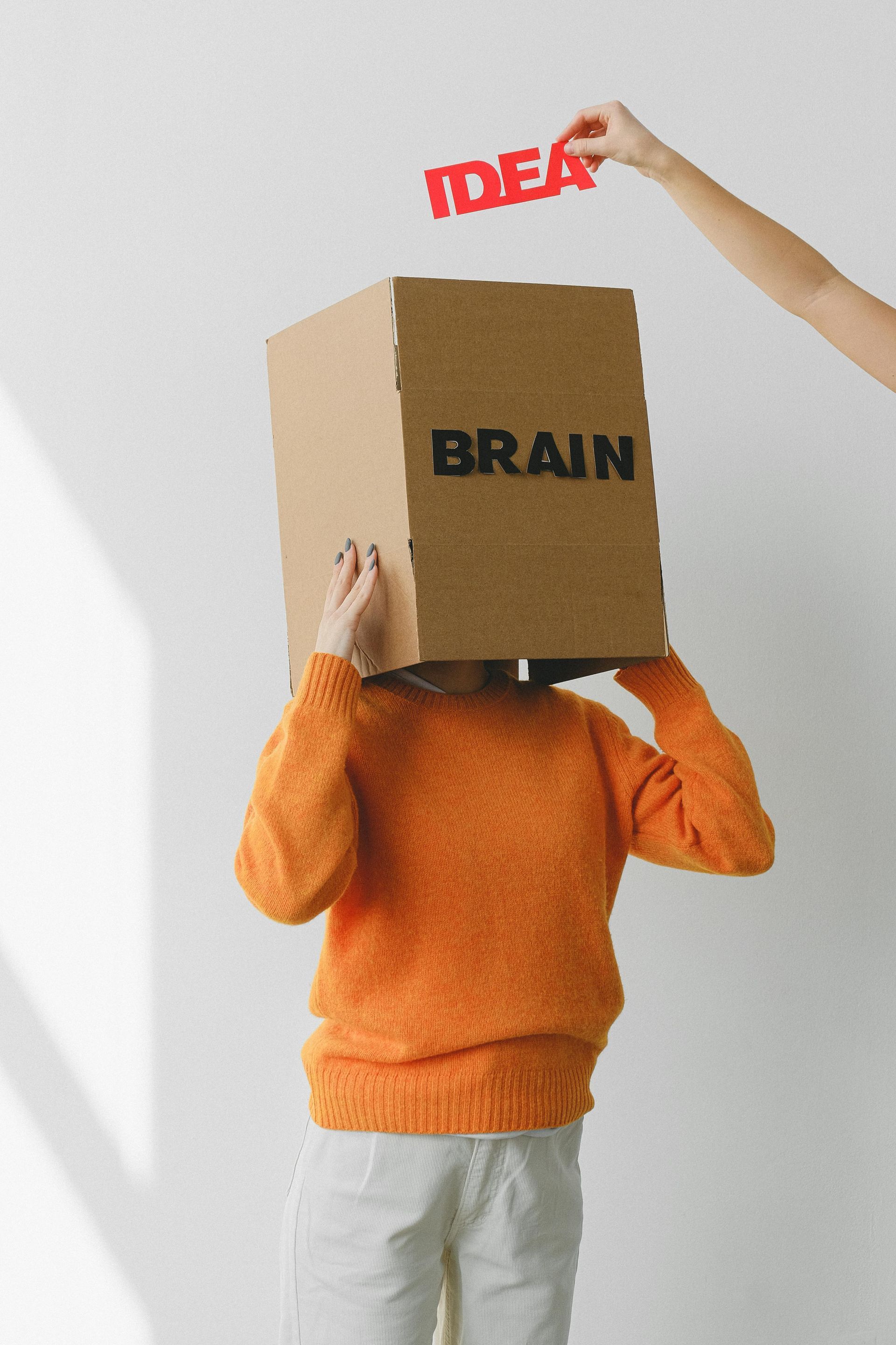 Person with a cardboard box labeled