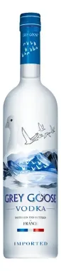 Botella de vodka Grey Goose con tapón azul y etiqueta blanca esmerilada sobre un fondo liso.