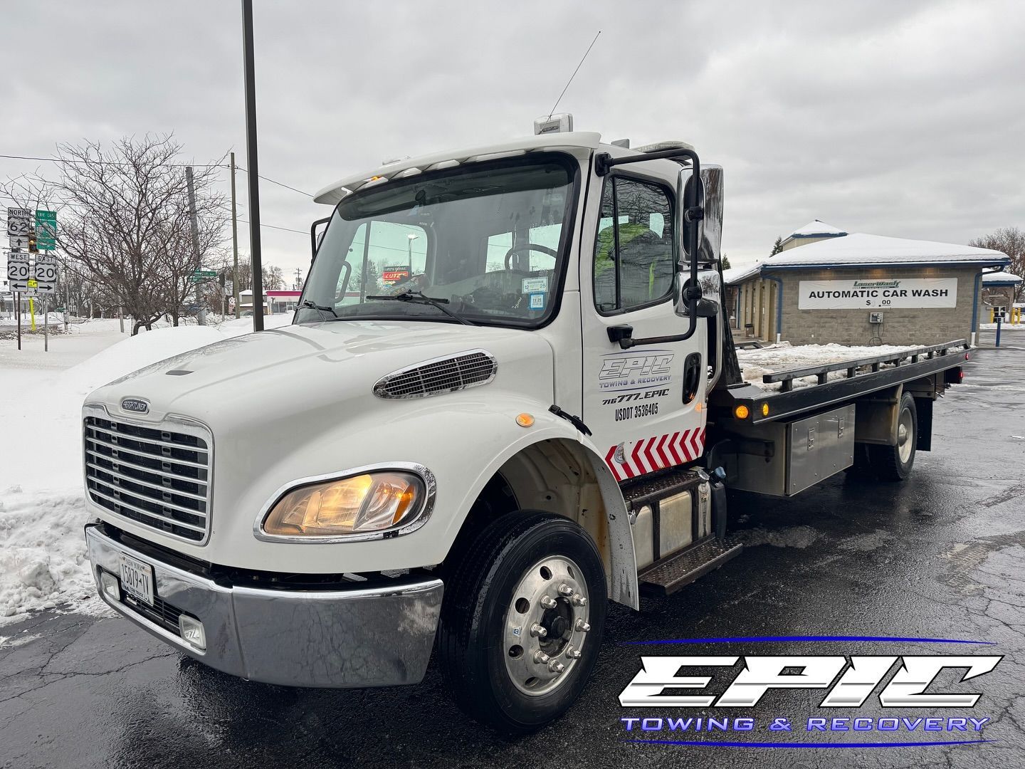 White flatbed tow truck parked outdoors in snowy weather, side view with EPIC logo watermark.
