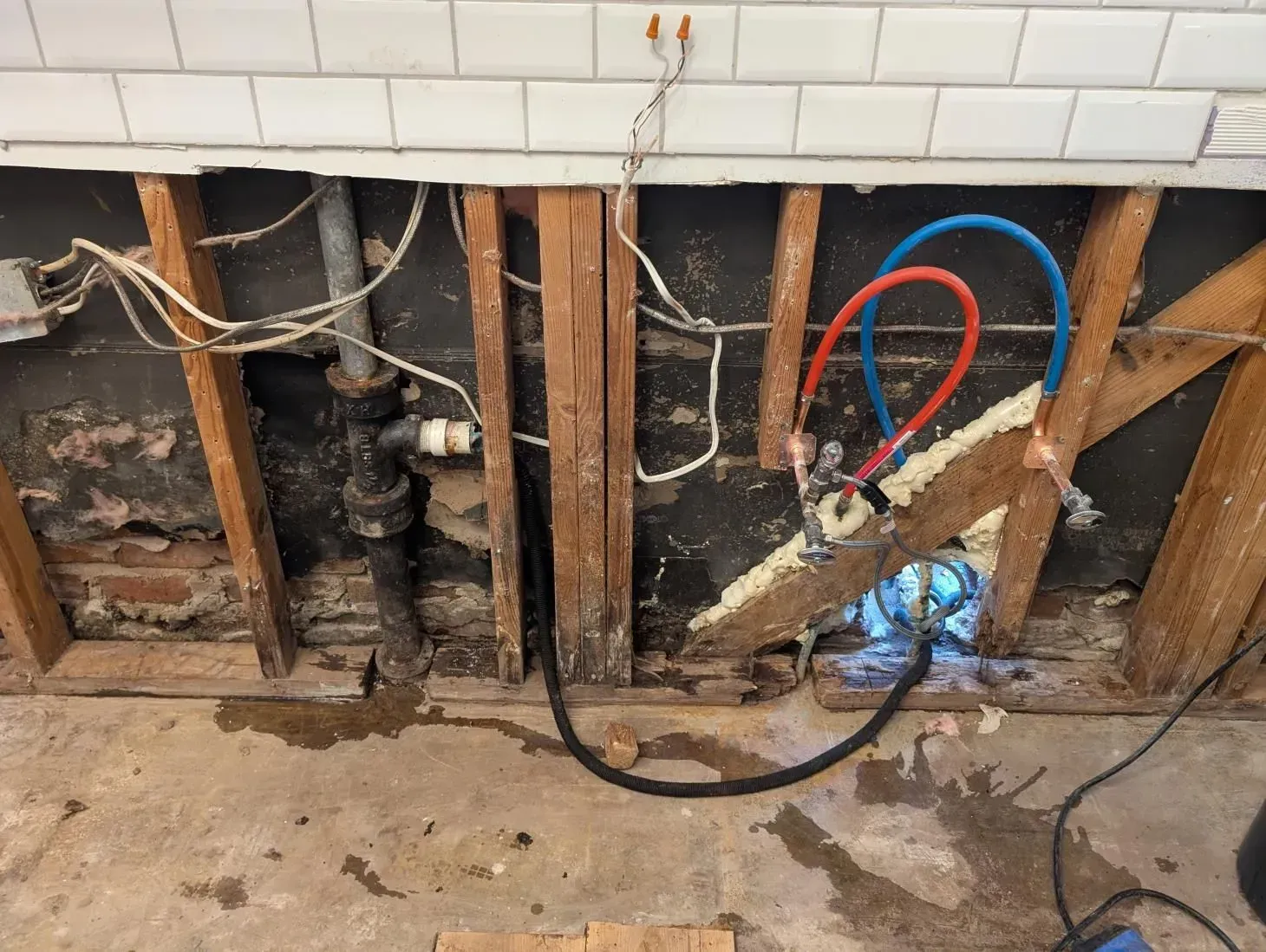 A bunch of pipes are connected to a wall.