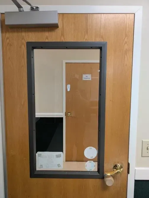 A wooden door with a mirror on it
