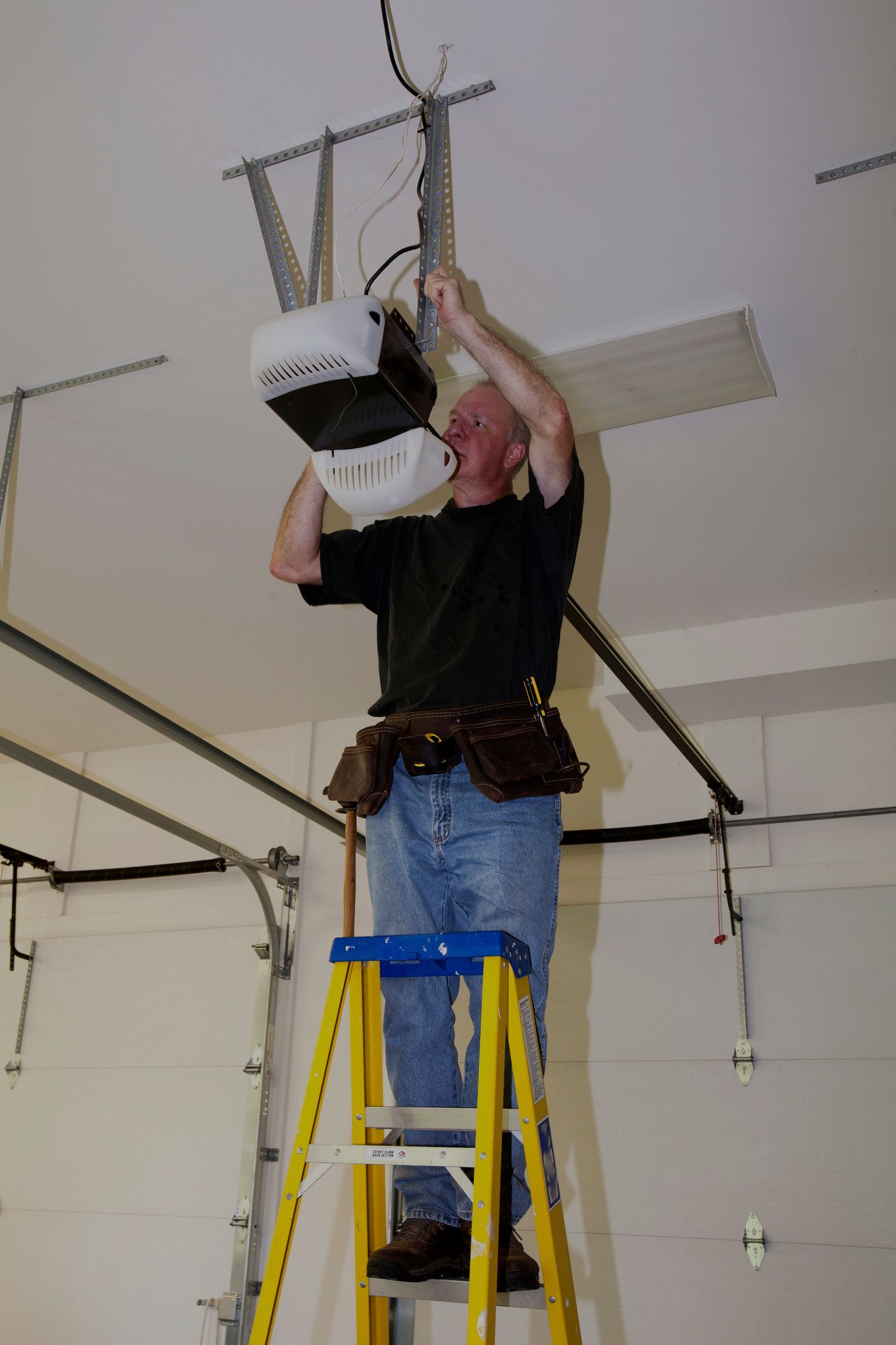 A man repairing garage door motor - Hagerstown, MD - J&B Garage Doors