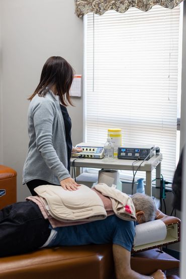 Therapist assisting a person receiving treatment.