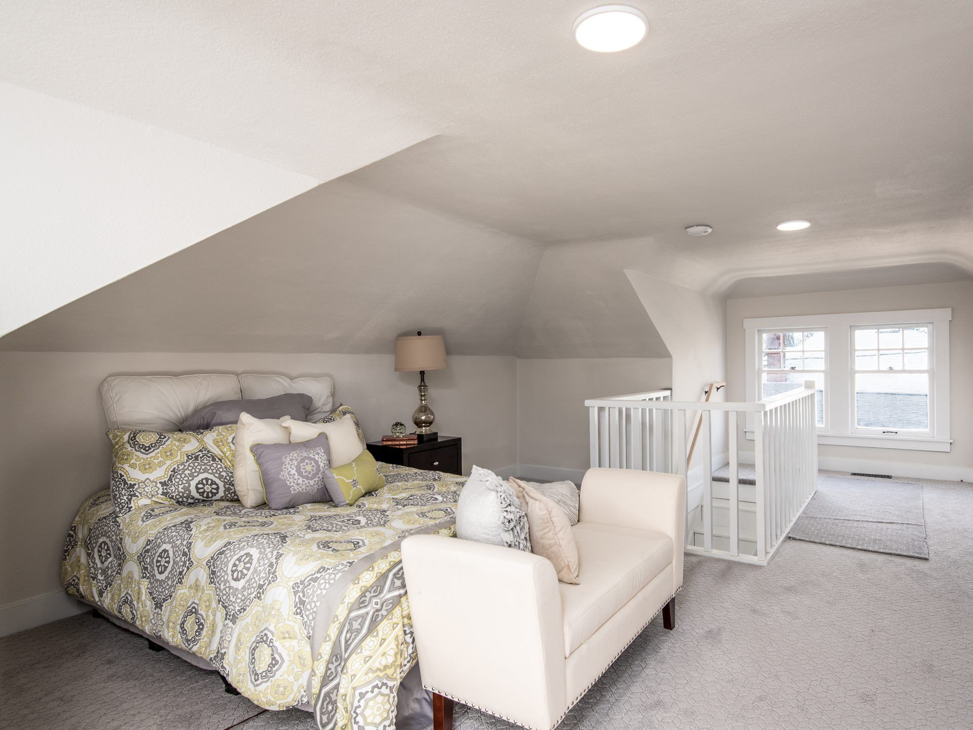 Picture of a bedroom with a bed and other furniture.