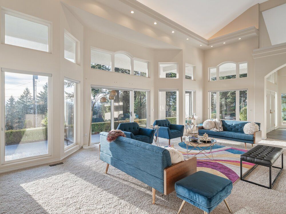 Photo of a living room with large windows.