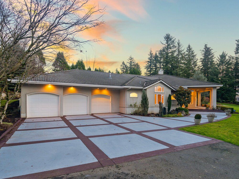 Photo of a single story home with a three car garage.