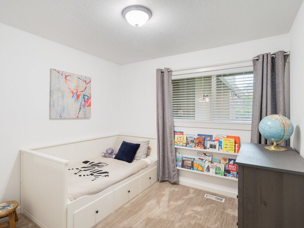 Photo of a kids bedroom well decorated with good lighting.