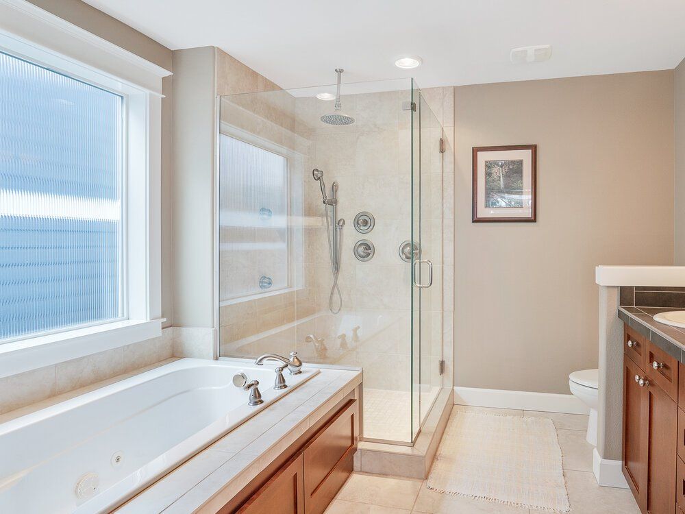 Photo of a bathroom with a stand up shower and a separate tub.