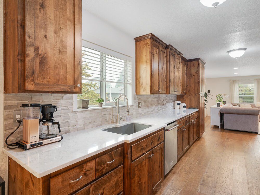 Photo of a kitchen counter with wood cabinets.
