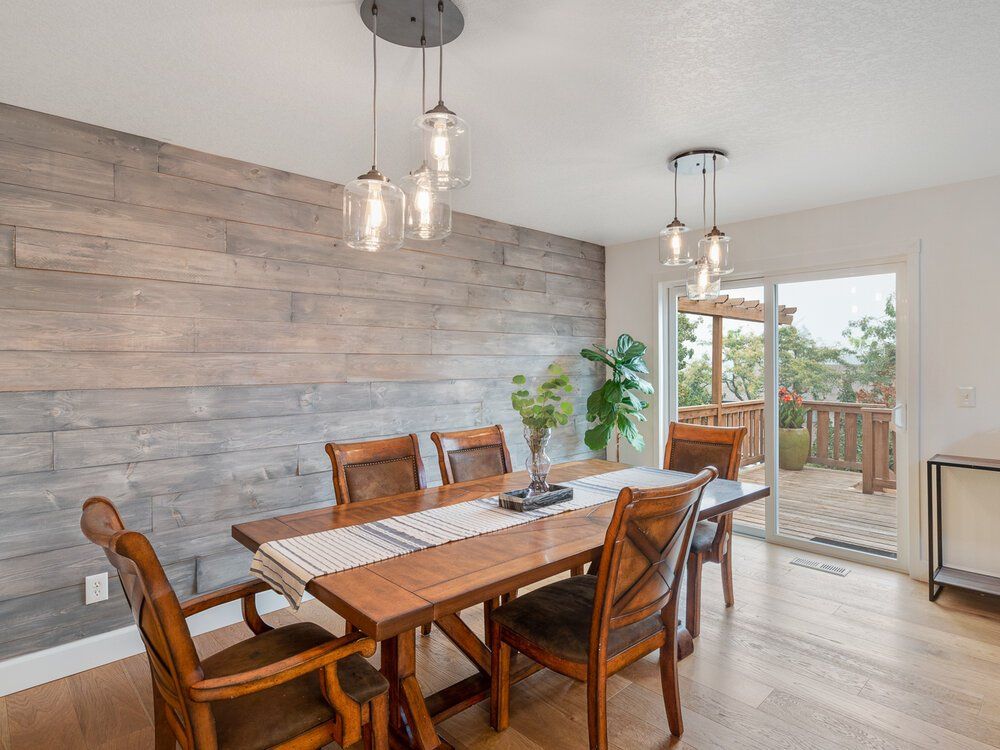 Photo of a dining room with nice reclaimed wood accent wall.