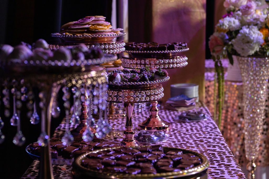 a table topped with a variety of desserts and flowers