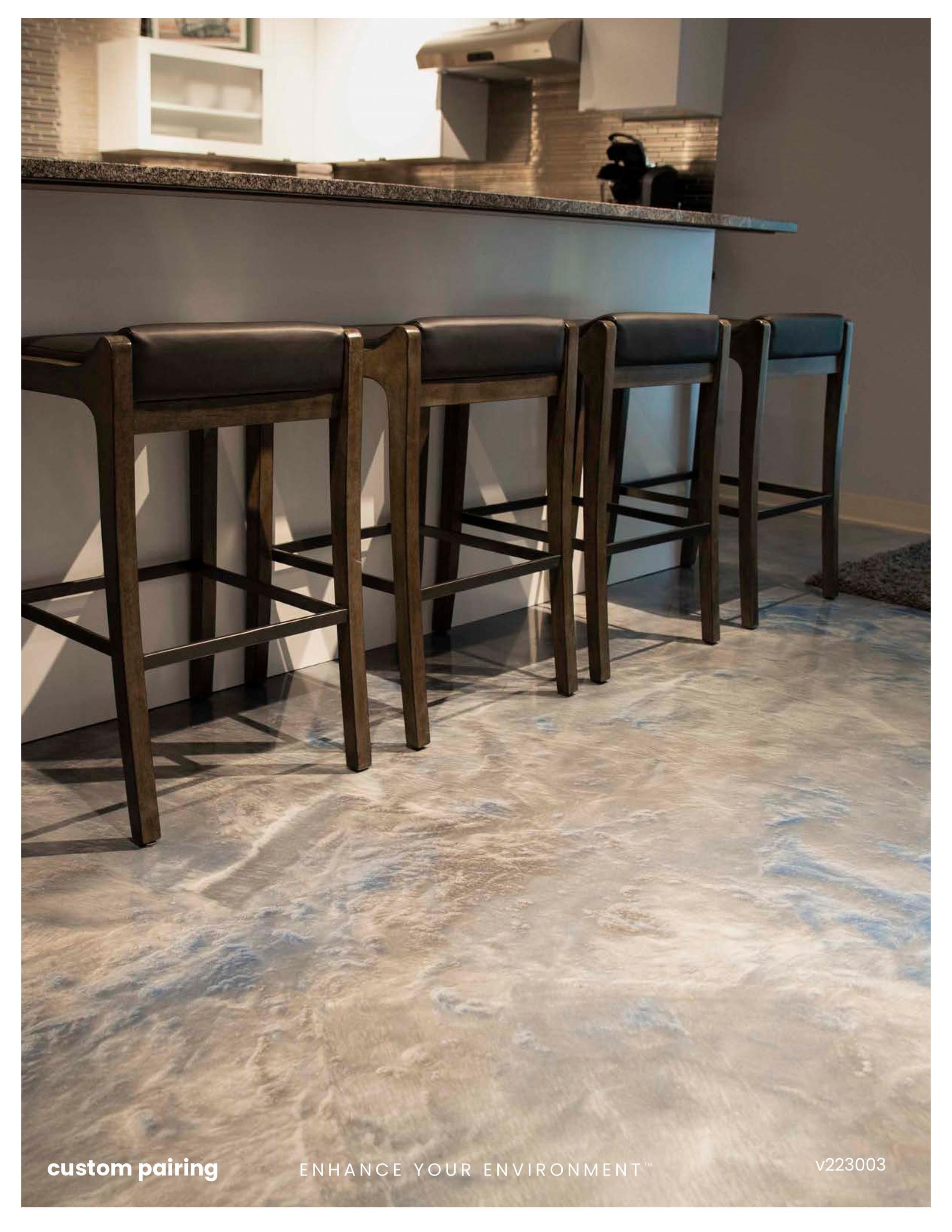 Kitchen counter with four dark wood bar stools over a light gray tiled floor.