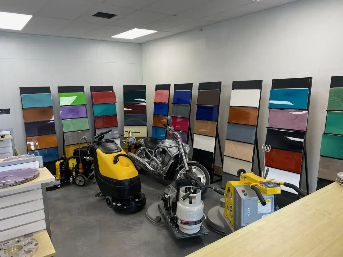 Storage room with shelving units holding colorful bins and cleaning equipment on the floor