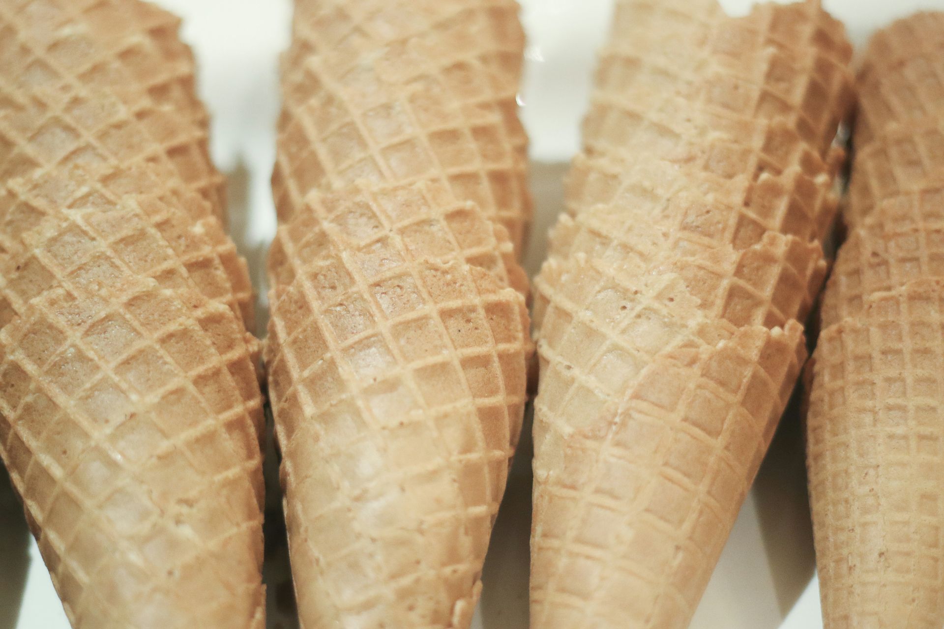 A row of ice cream cones sitting on top of each other on a table.