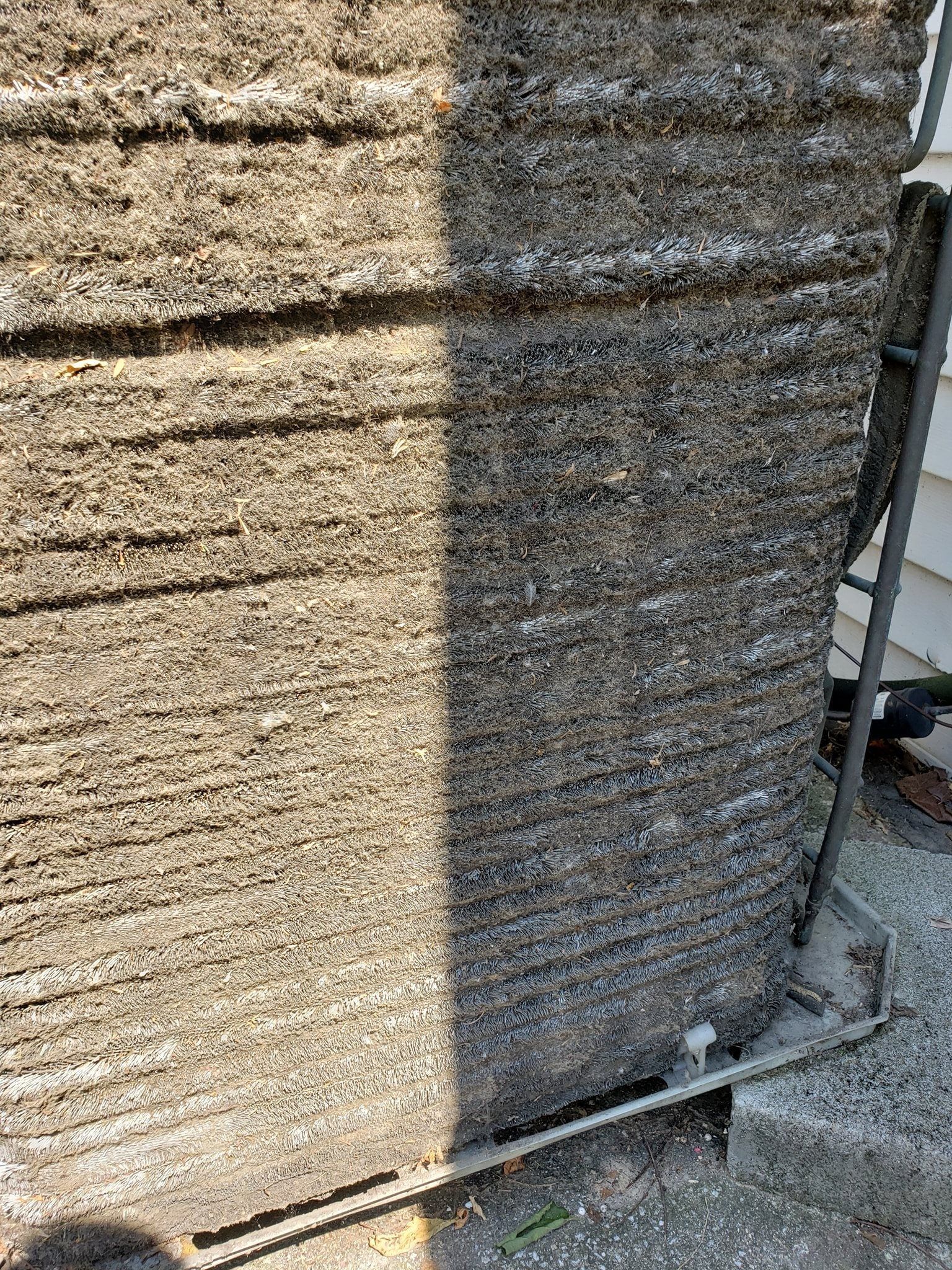 A close up of a brick wall with a hose attached to it.